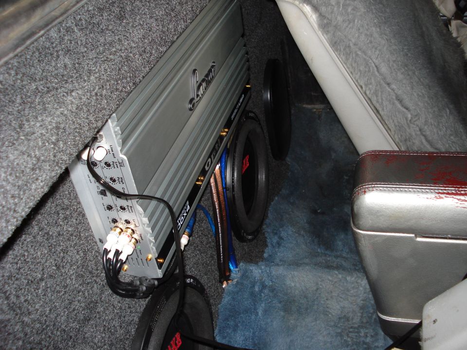 Lanzar amplifier and MTX subwoofer installed in a carpeted rear compartment