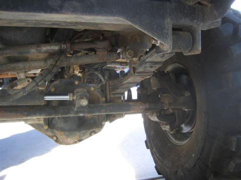1994 Ford Bronco - Close-up of the vehicle's undercarriage, showing the suspension and axle assembly.
