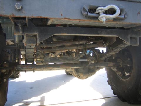 1994 Ford Bronco - Close-up view of the undercarriage, showing suspension and drivetrain components, with a winch hook attached to the frame.
