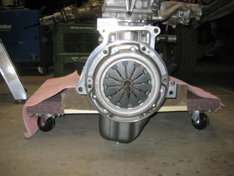 1987 Suzuki Samurai - Engine clutch assembly on a dolly, likely for repair or replacement.