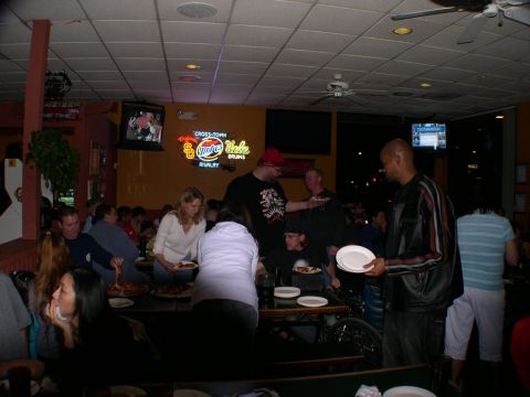 2007 Toyota FJ Cruiser - A group of people are socializing and eating in what appears to be a restaurant or bar.