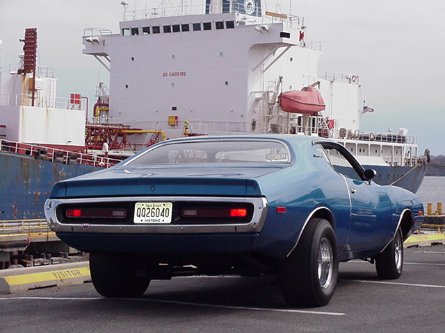 1971 Dodge Charger rear view, parked by a ship. License plate reads 0026040