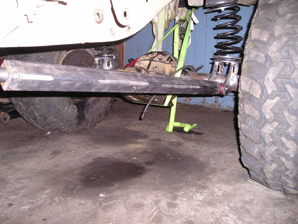 Close-up of a vehicle's rear suspension with a large tire and metal components