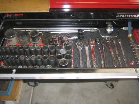 1994 Ford Bronco - A collection of sockets and wrenches are neatly organized within a tool drawer.