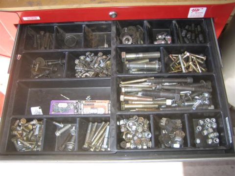 1994 Ford Bronco - A red toolbox drawer is organized with various types of fasteners and hardware for easy access.