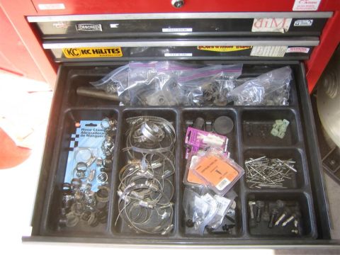 1994 Ford Bronco - A red toolbox drawer contains various sizes of hose clamps and fasteners, organized into compartments.