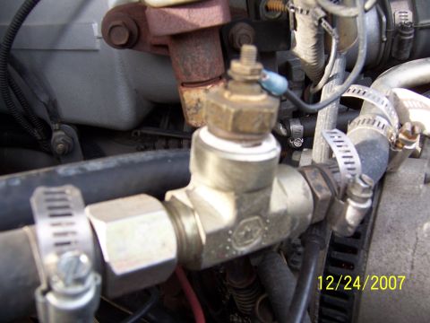 1994 Ford Bronco - Engine coolant temperature sensor fitting with hoses attached, photographed on 12/24/2007.
