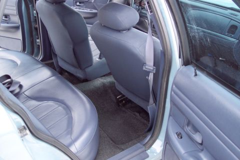 2001 Ford Crown Victoria - Rear interior view of a 2001 Ford Crown Victoria, showing the back seats and door panel.