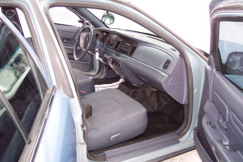 2001 Ford Crown Victoria - The interior of a 2001 Ford Crown Victoria is visible, with the driver's side door open.