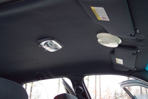 2001 Ford Crown Victoria - Interior view of a car's ceiling, showing dome lights and a sun visor with safety information.