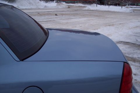 2001 Ford Crown Victoria - The rear of a car is shown, with a snowy parking lot visible in the background.
