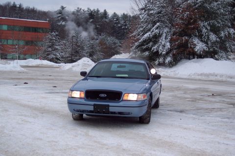 2001 Ford Crown Victoria - Front view of a blue 2001 Ford Crown Victoria in a snowy environment.