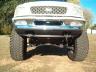 1990 Ford Bronco - Front view of a lifted 1990 Ford Bronco with oversized tires.