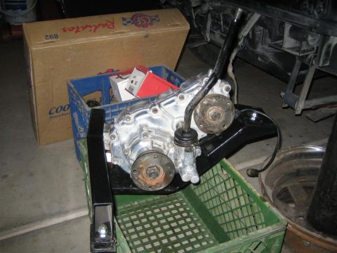 1987 Suzuki Samurai - A transfer case, likely for an off-road vehicle, is shown with its chrome housing and black shifter.