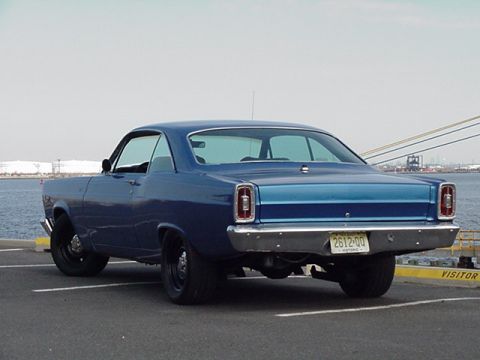 1966 Ford Fairlane - Rear view of a blue 1966 Ford Fairlane coupe parked near a body of water.