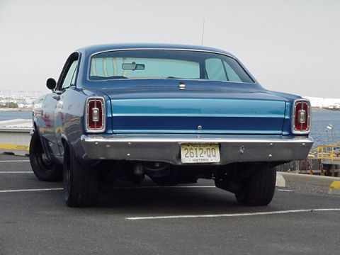 1966 Ford Fairlane - The rear of a blue sedan with a chrome bumper and a license plate reading '2612-QQ'.