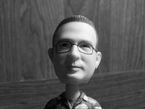 1973 Ford Ranchero - A bobblehead figure wearing glasses is shown in a close-up shot.