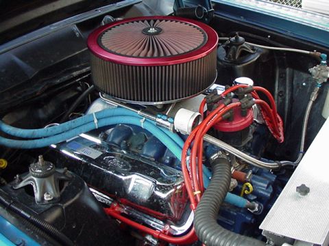 1966 Ford Fairlane - Close-up view of the engine bay of a 1966 Ford Fairlane, showing the air filter, distributor, and engine components.