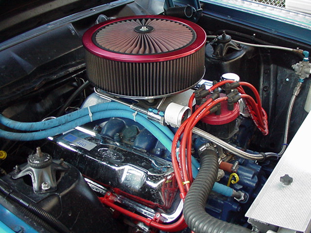 Ford V8 engine with chrome valve covers and red round air cleaner