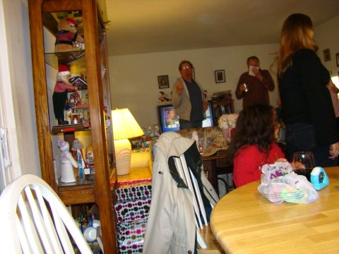 1989 Ford Bronco - A group of people are gathered in a room decorated for the holidays, with a display cabinet and a table in the foreground.