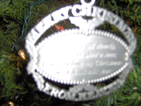 1978 Ford Bronco - A silver Christmas ornament with text is hanging on a green tree.