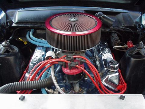 1966 Ford Fairlane - Engine bay of a 1966 Ford Fairlane, a prominent air filter and V8 engine components.