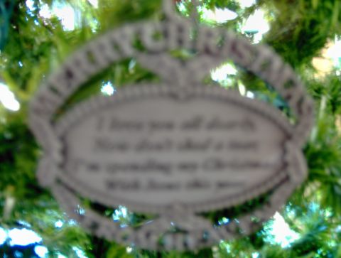 1978 Ford Bronco - A Christmas ornament hangs on a tree, displaying a message about missing someone during the holidays.
