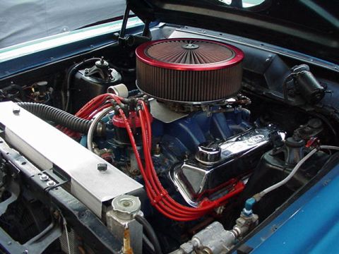 1966 Ford Fairlane - Close-up view of a V8 engine, a prominent air filter and red spark plug wires.