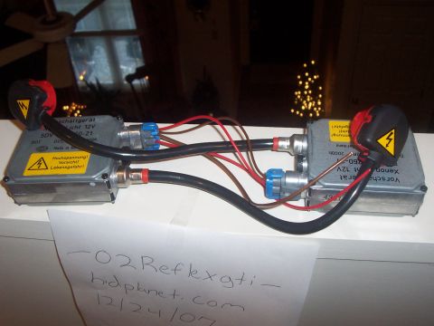 1993 Ford Probe - Two HID ballast units are shown, each with wiring and warning labels indicating high voltage.