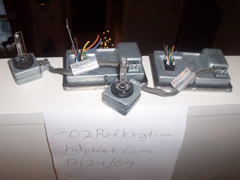 1993 Ford Probe - HID ballasts and bulbs are shown on a white surface with handwritten notes and a SuperMotors logo.