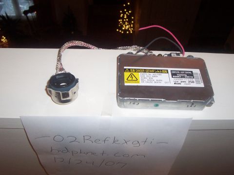 1993 Ford Probe - A car headlight ballast and connector are shown, with text indicating Toyota and warning labels.
