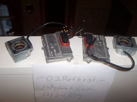 1993 Ford Probe - Two HID ballasts and igniters are shown, with handwritten notes and a website on paper in front.
