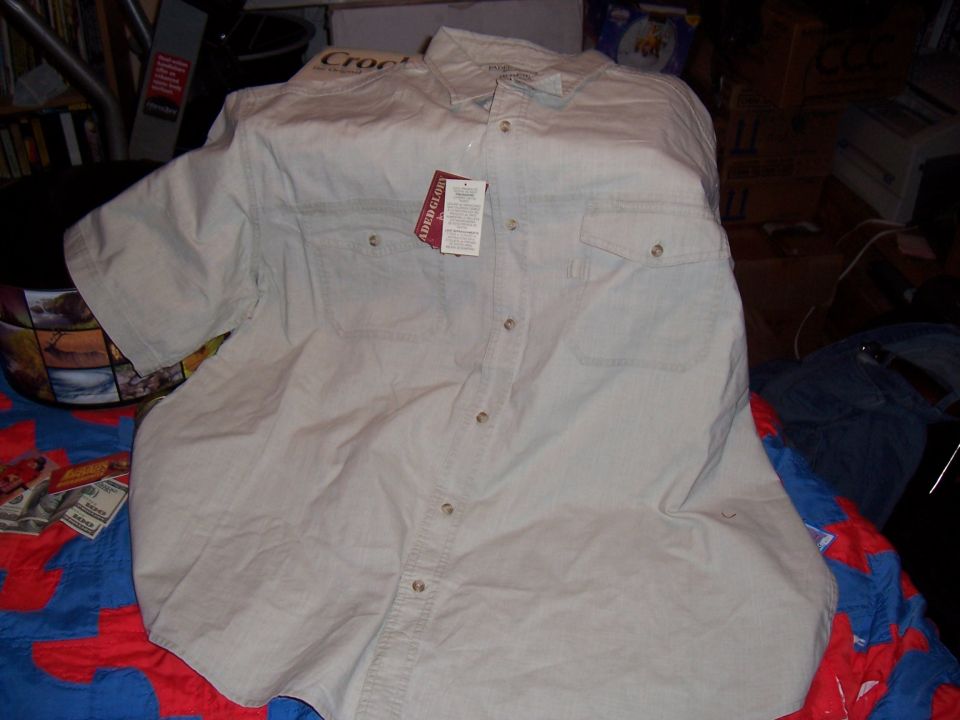 Beige short-sleeve button-up shirt with two chest pockets and tags attached