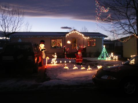 1995 Ford Bronco - Christmas decorations adorn a house and yard, with two vehicles present.