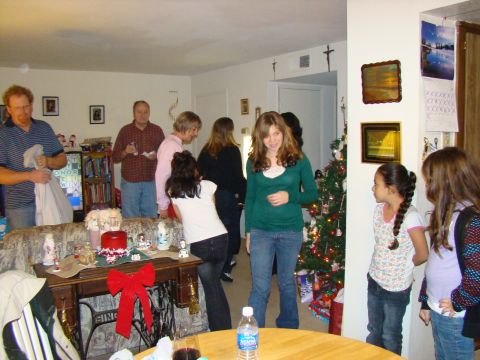 1989 Ford Bronco - A group of people are celebrating Christmas in a decorated living room.