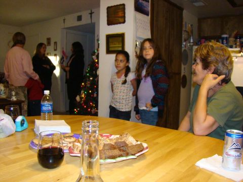 1989 Ford Bronco - A group of people are seen in a room, with a Christmas tree in the background and snacks on a table.