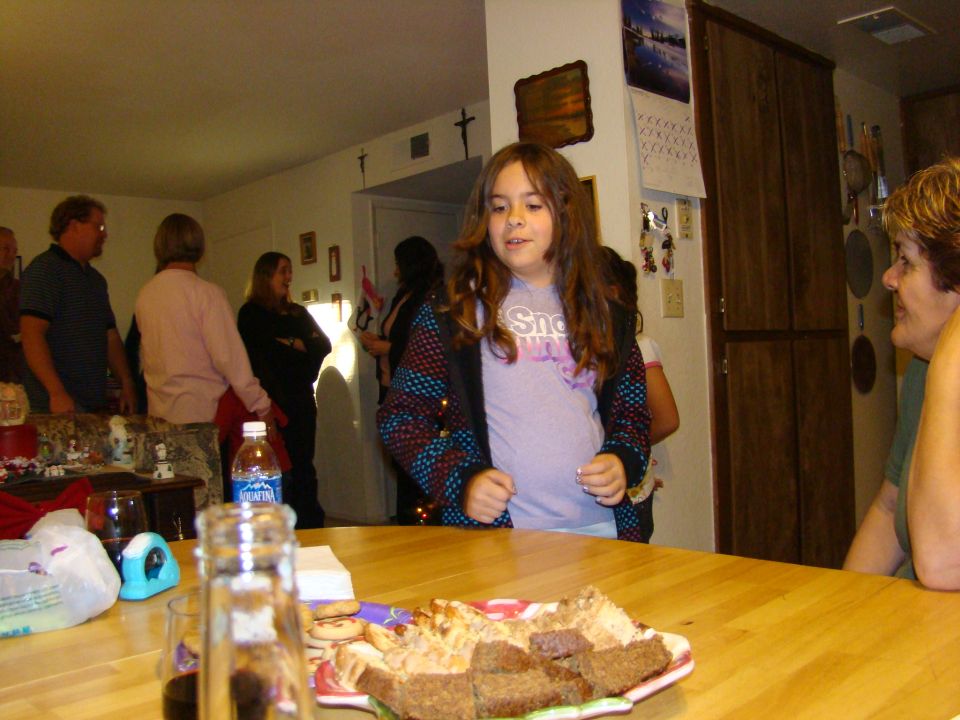 Indoor gathering with people and food on a table