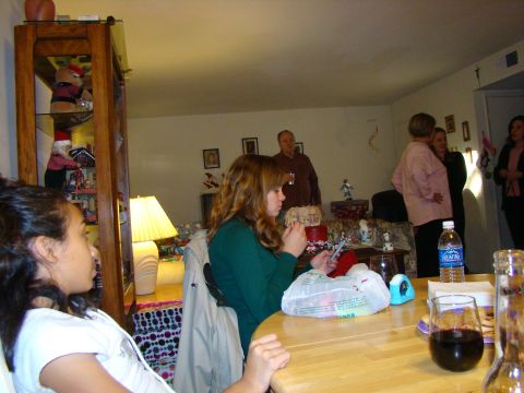 1989 Ford Bronco - A group of people are gathered indoors, with some seated at a table and others standing in the background.