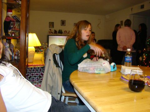 1989 Ford Bronco - A group of people are seen indoors during a gathering, with a table laden with food and drinks.