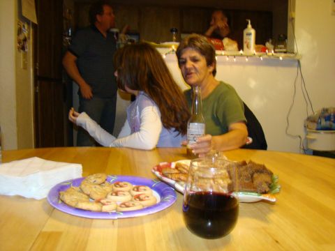 1989 Ford Bronco - A casual gathering around a table laden with cookies, bread, and drinks, with several people in the background.