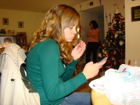 1989 Ford Bronco - Two women in a room decorated for Christmas, one is looking at her phone.