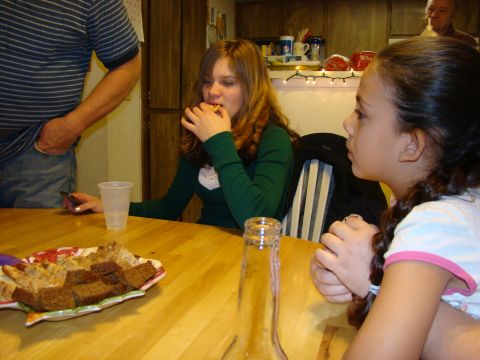 1989 Ford Bronco - A group of people are seated at a table, with food and drinks present.