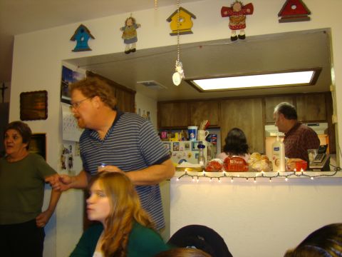1989 Ford Bronco - A gathering of people in a home kitchen, with decorations visible on the wall and counter.