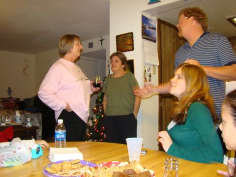 1989 Ford Bronco - A group of people are gathered indoors, possibly for a holiday celebration, with food and drinks on a table.