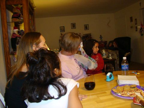 1989 Ford Bronco - A group of people are gathered around a table indoors, with cookies and drinks visible.