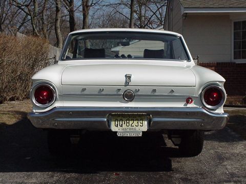1966 Ford Fairlane - This classic Ford Falcon features a distinctive rear end with prominent circular taillights and a chrome bumper.