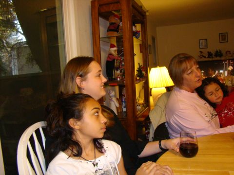 1989 Ford Bronco - A family gathering around a table, with a display cabinet filled with holiday decorations in the background.