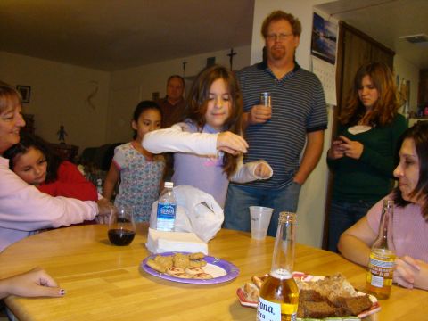 1989 Ford Bronco - A family gathering indoors around a table laden with food and drinks.