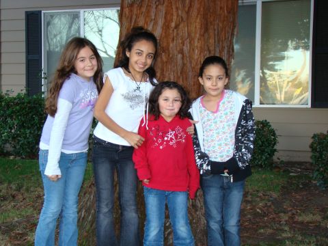 1989 Ford Bronco - Four girls pose for a photo in front of a tree and a house.