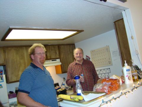 1989 Ford Bronco - Two men are in a kitchen, with cabinets and a counter visible. One man is on the left, the other on the right.